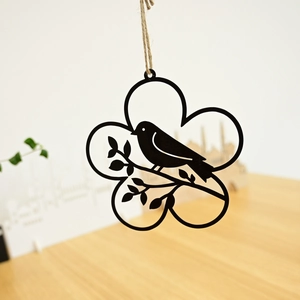 Detail of black metal Easter wreath silhouette with bird on branch and hemp rope hanger
