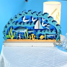 Detailed view of multilayer 3D nautical wood craft with whale and ocean motifs