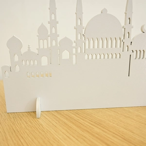 Detailed close-up of white wooden mosque silhouette decoration with hollow-out carving