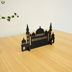 Detail of laser-cut black mosque silhouette wooden ornament for Muslim home decor