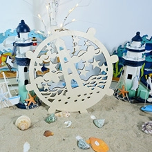 Detail of wooden LED ocean bridge lamp with lighthouse and stars in steering wheel shape