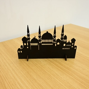 Detailed view of a black laser-cut mosque silhouette desktop ornament for Ramadan decor