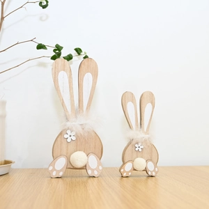 Detailed view of two wooden Easter bunnies with soft fur collars and natural wood textures