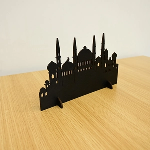 Detail of laser-cut black mosque silhouette desktop ornament for Ramadan and Eid decor