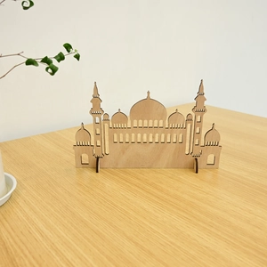 Detailed laser-cut wooden mosque ornament for Ramadan home decor on a natural wooden table