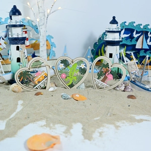 Detailed close-up of three wooden heart ornaments featuring colorful IBIZA tropical motifs
