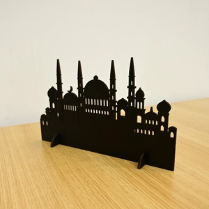 Detail of laser-cut wooden Muslim silhouette ornament with mosque dome and crescent