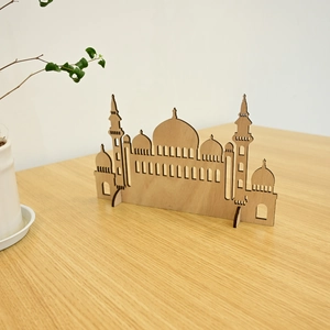Detailed laser-cut wooden mosque silhouette with natural texture for Ramadan desk decor