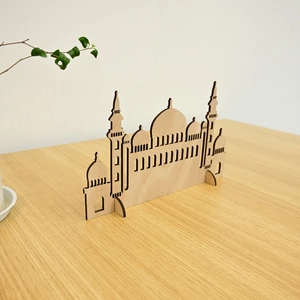 Macro detail of laser-cut wooden mosque silhouette desk ornament for Muslim holiday decor