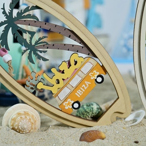 Detail of wooden surfboard ornament with Ibiza car and palm tree on a sandy beach