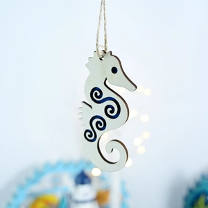 Detail of wooden seahorse wall hanging with blue resin inlay and rustic twine rope