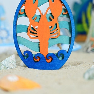 Detailed layered wooden lobster wall art with Mediterranean ocean waves in bright blue and orange