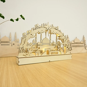 Detail of wooden LED moon lamp with laser-cut mosque design and warm backlit effect