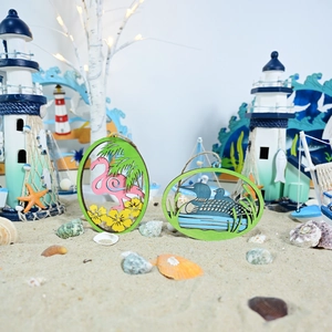 Tropical wooden pendants with flamingo and loon designs in a beach scene setting