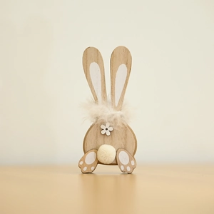 Close-up of wooden bunny with natural grain and white painted ear and paw accents