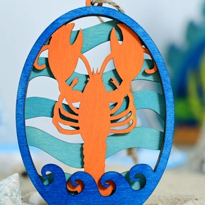 Macro detail of wooden lobster wall hanging with multi-layered ocean wave laser cut design