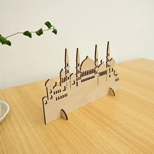 Macro detail of laser-cut wooden mosque silhouette ornament for Muslim home decor
