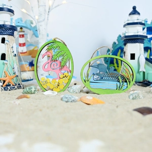 Detail of laser-cut wooden summer ocean plaques with flamingo and loon motifs