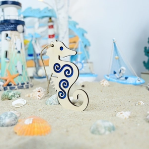 Detail of a wooden seahorse wall hanging with blue swirl art and nautical decor accents