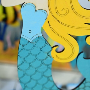 Detailed laser-engraved fish scales and hair lines on a wooden mermaid pendant
