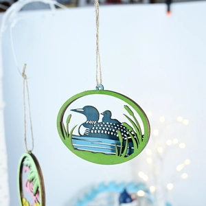 Detail of layered wood sea loon wall hanging with 3D depth and rustic jute rope