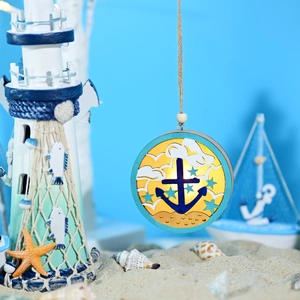 Detail of Mediterranean round wooden LED lamp with anchor and star icons on micro beach scene