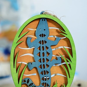Detail of laser-cut layered wooden lizard wall decor with nautical Mediterranean style