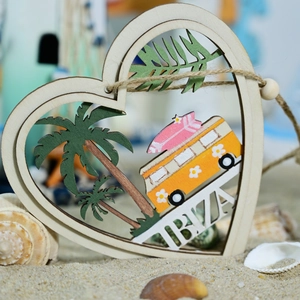 Detail of heart-shaped wooden Ibiza ornament with palm tree and yellow surf bus