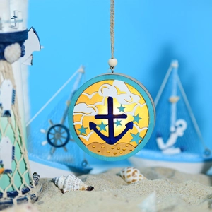Detail of nautical LED ball lamp with anchor motif on sand with beach accessories