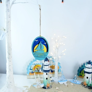 Detail view of a multi-layer wooden ocean sailboat pendant with rustic hemp rope