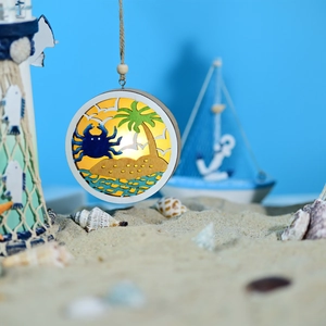Detail of the wooden LED ocean light with layered crab and palm tree carvings