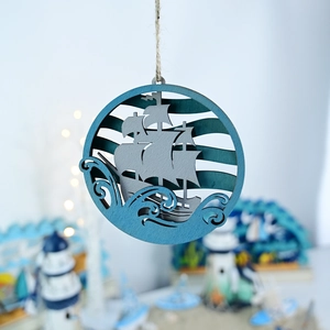 Detail of multi-layered wooden sailboat ornament with laser-cut ocean waves and hemp rope