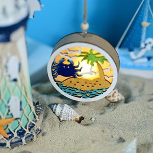 Detail of wooden ocean-themed LED orb featuring 3D carved blue crab and beach scenery