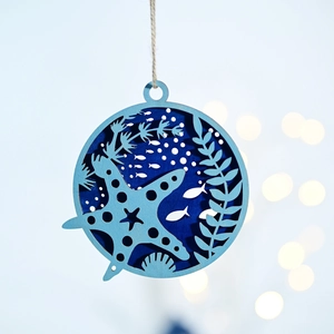 Detail of nautical wooden wall hanging featuring layered starfish and sea grass carving
