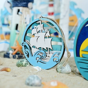 Detail of wooden 3D nautical wall decor featuring white sailboat and blue waves