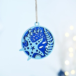 Close-up of ocean-themed wooden wall decor with sea stars and fish in dual blue tones