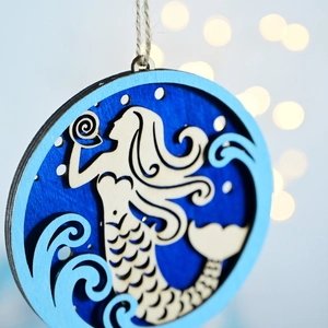 Detailed close-up of a multilayer wooden mermaid wall hanging with nautical wave patterns
