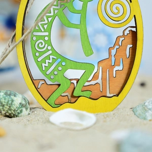 Macro detail of wooden Kokopelli ornament with jute rope on a beach with sea shells