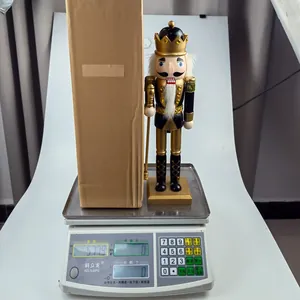 Detail of black and gold nutcracker king doll on scale weighing approximately 578g
