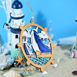 Detail of wooden ship wheel ornament with sailboat decor in nautical beach setting