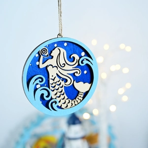 Close-up of laser-cut wooden mermaid plaque with Mediterranean style blue layers