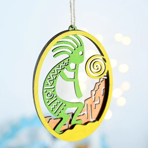 Detail of wooden Kokopelli ornament with layered colorful wood and hanging rope decoration