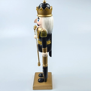 Detailed side view of black and gold wooden nutcracker king with crown and scepter decor