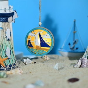 Detail of nautical LED ocean ball lamp with sailboat cutout and warm glowing light effect