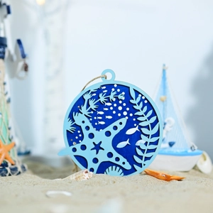 Close-up of layered wooden marine wall art with starfish and rope hanger for home decor