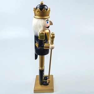 Detail of a black and gold Nutcracker king with a crown and faux fur hair on a square base