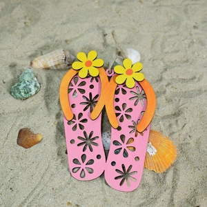 Detail of wooden flip-flop ornaments with hollow flower patterns and rope hangers