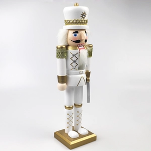 Detail of 30cm white and gold wooden nutcracker soldier with intricate golden embroidery