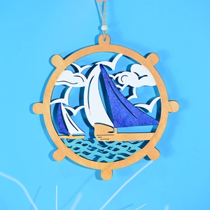 Detail of wooden nautical anchor wall hanging with laser-cut sailboat and wave layers