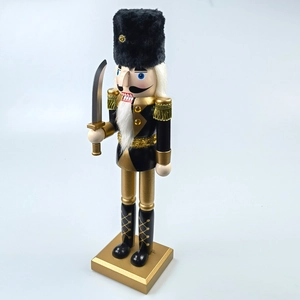 Detail view of a black and gold Nutcracker soldier with fur hat and golden tassels